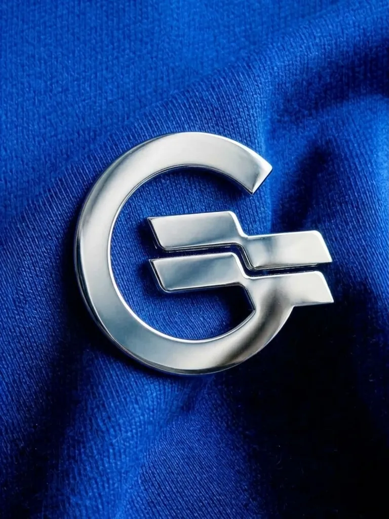 Chrome Geelong Air logo mark pressed into blue fabric